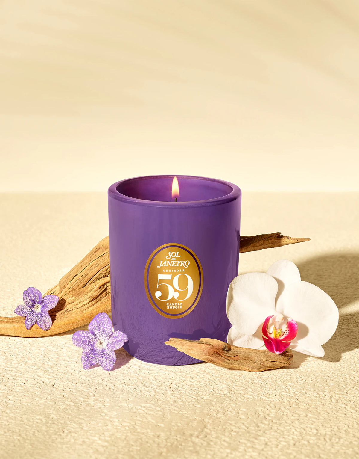 SOL DE JANEIRO Cheirosa '59 scented candle in a glass jar with a warm, inviting glow and floral fragrance.